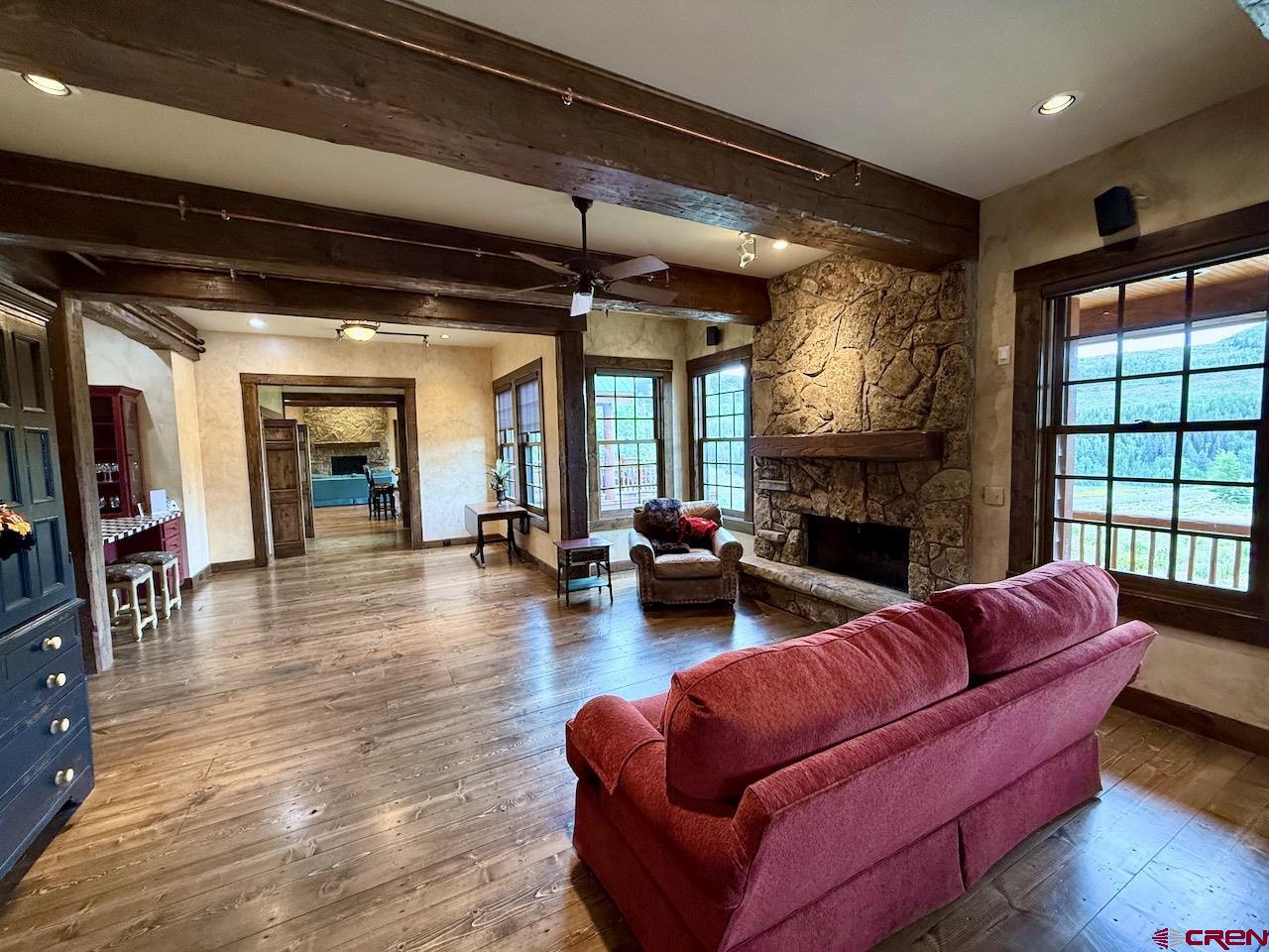 88 Castle Rock Court Crested Butte, CO 81224 - Photo 12 of 44 a living room with furniture fireplace and a large window