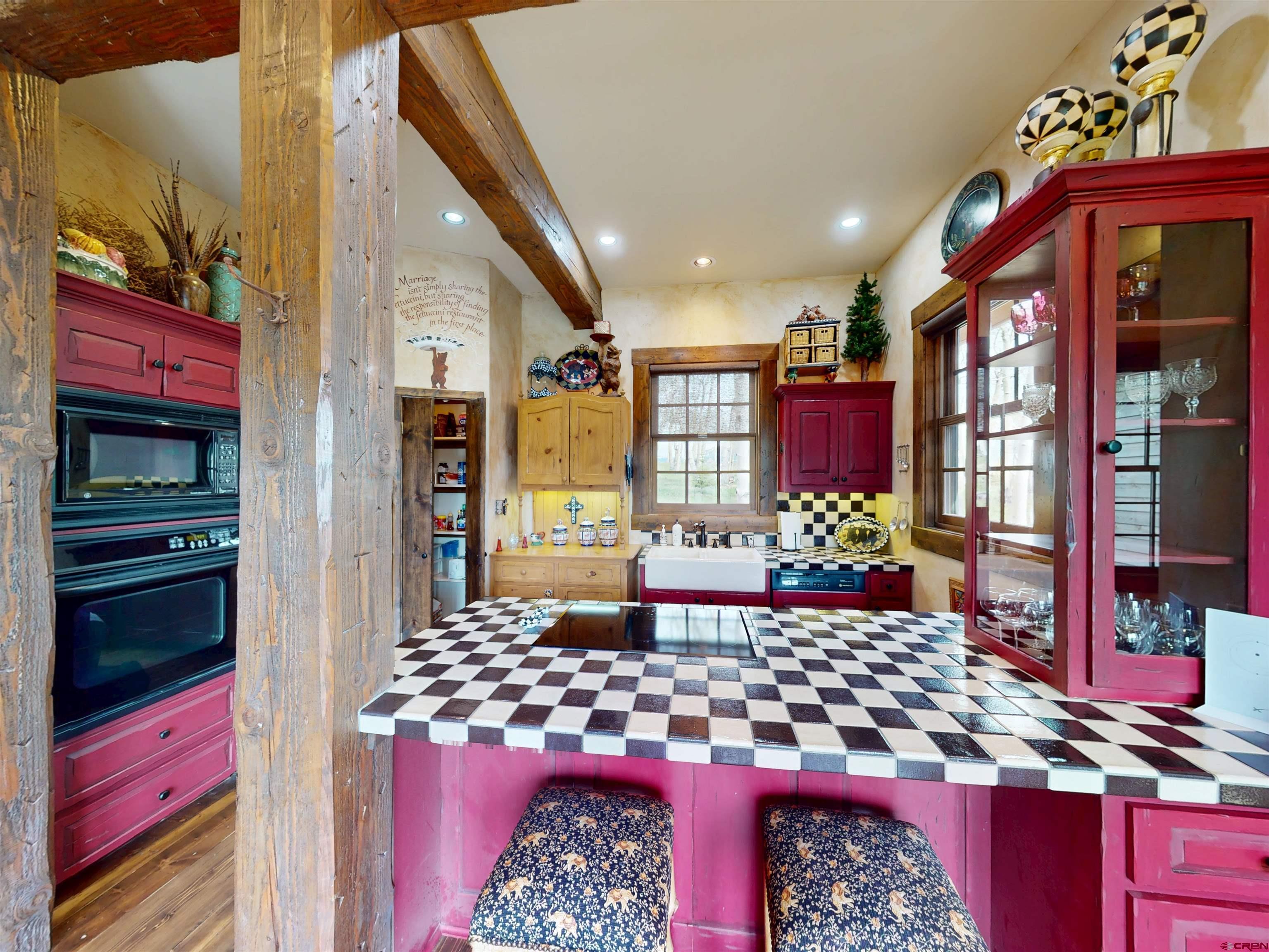 88 Castle Rock Court Crested Butte, CO 81224 - Photo 15 of 44 a kitchen with stainless steel appliances kitchen island granite countertop a stove and cabinets
