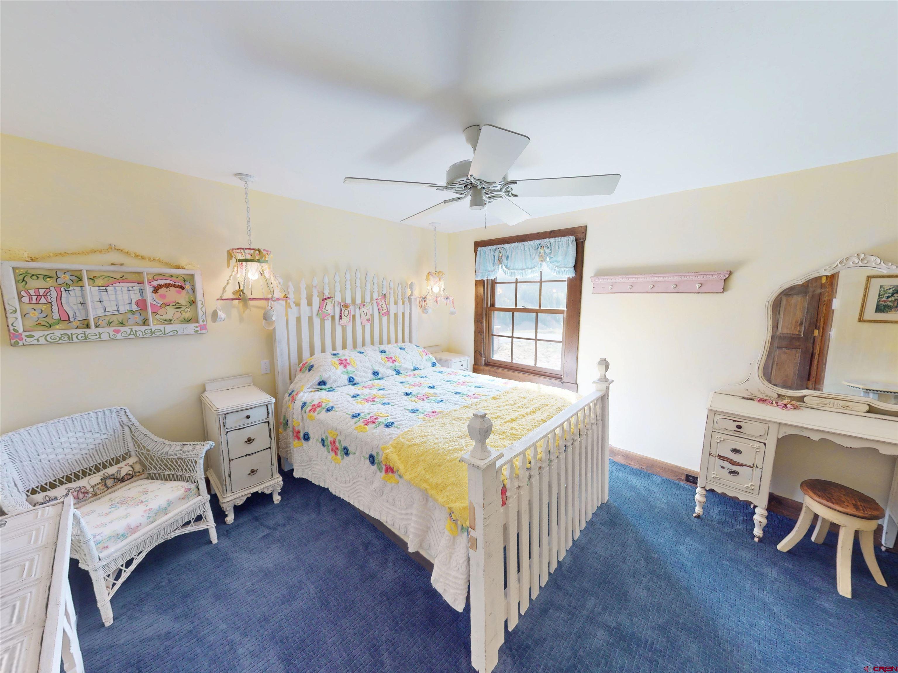 88 Castle Rock Court Crested Butte, CO 81224 - Photo 39 of 44 a bedroom with a bed and a chandelier