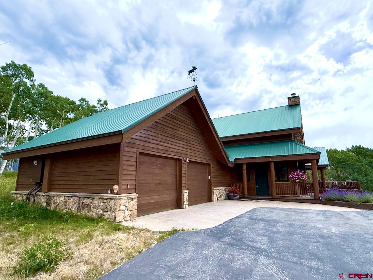 88 Castle Rock Court Crested Butte, CO 81224 - Photo 44 of 44 a front view of a house with a yard and garage