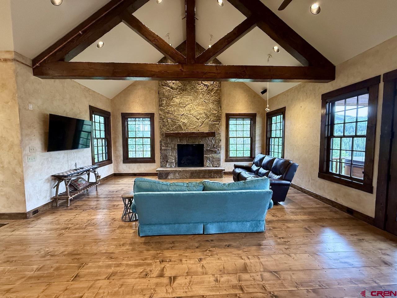 88 Castle Rock Court Crested Butte, CO 81224 - Photo 6 of 44 a living room with fireplace furniture and a flat screen tv