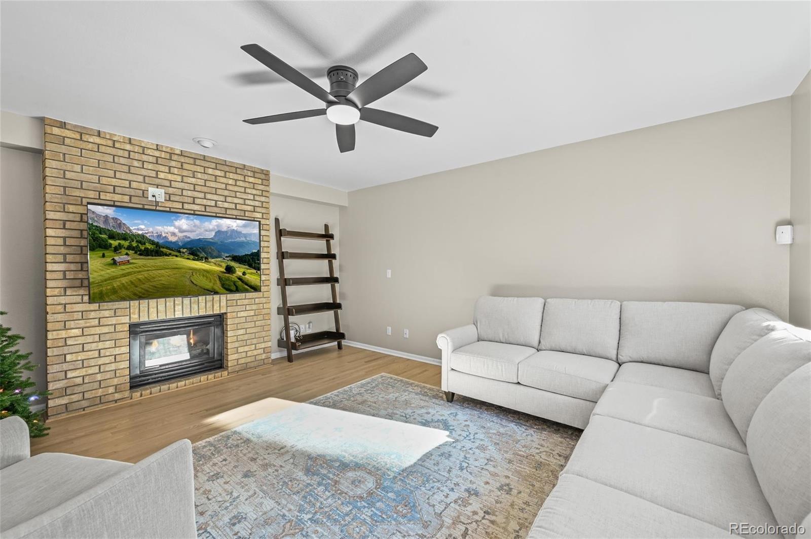 10096 Hughes Place Highlands Ranch, CO 80126 - Photo 11 of 50 a living room with furniture and a fireplace