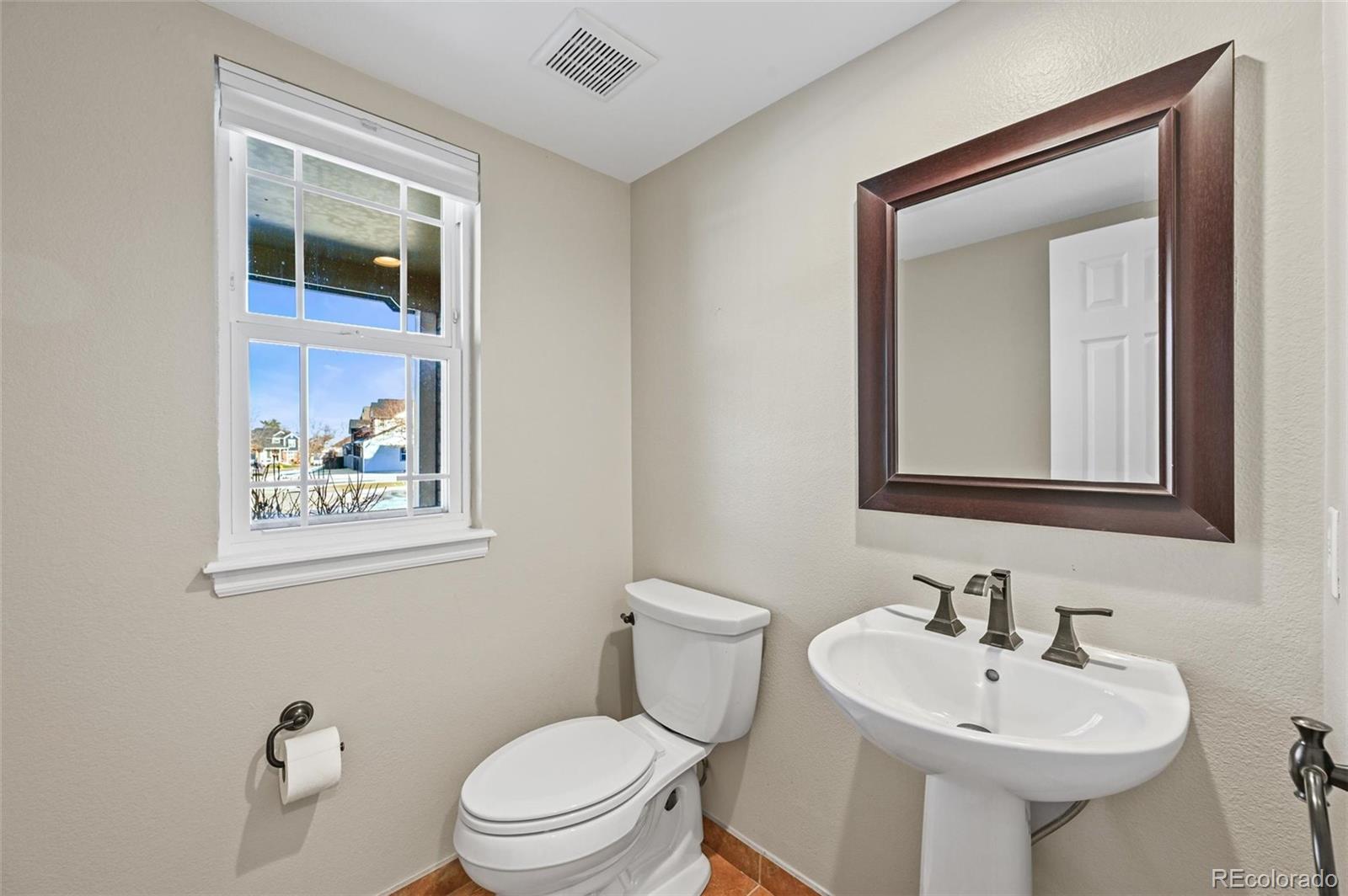 10096 Hughes Place Highlands Ranch, CO 80126 - Photo 14 of 50 a bathroom with a toilet sink and mirror