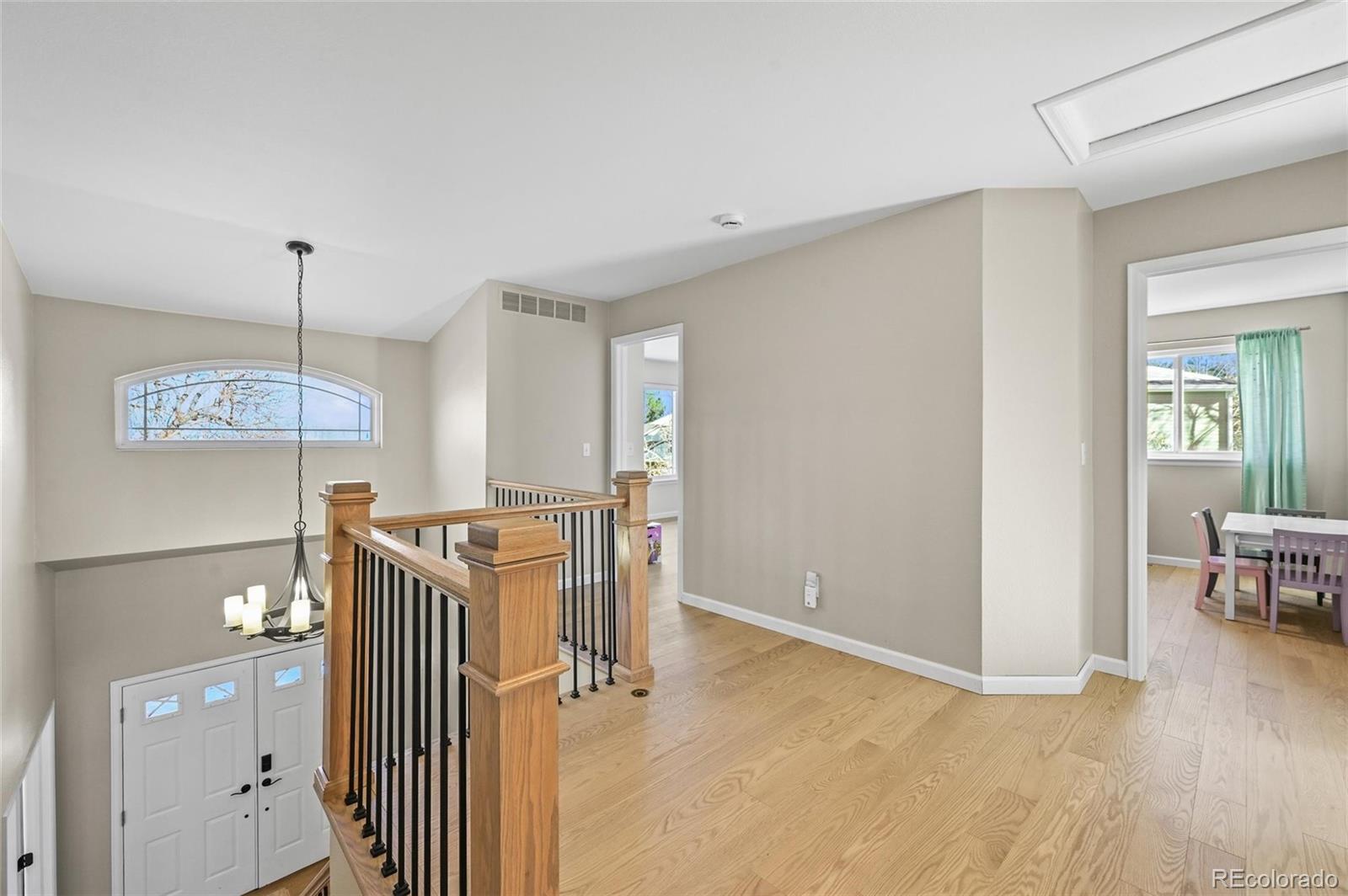 10096 Hughes Place Highlands Ranch, CO 80126 - Photo 17 of 50 a view of a livingroom with furniture wooden floor and windows
