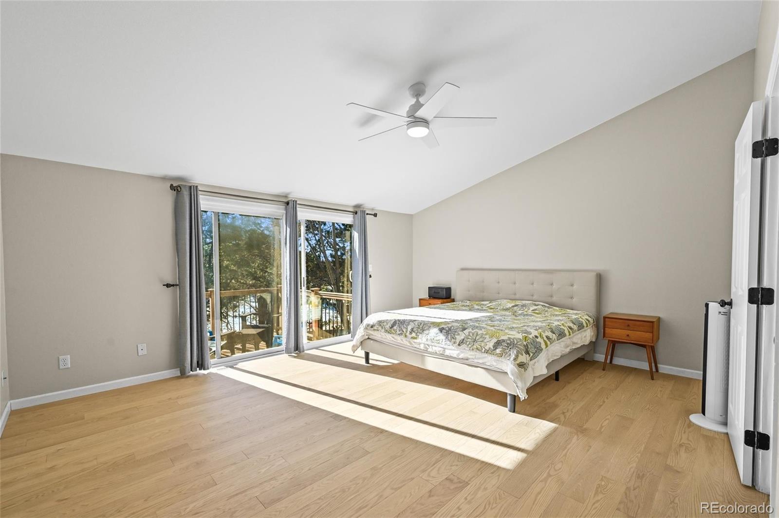10096 Hughes Place Highlands Ranch, CO 80126 - Photo 19 of 50 a spacious bedroom with a bed and a large window