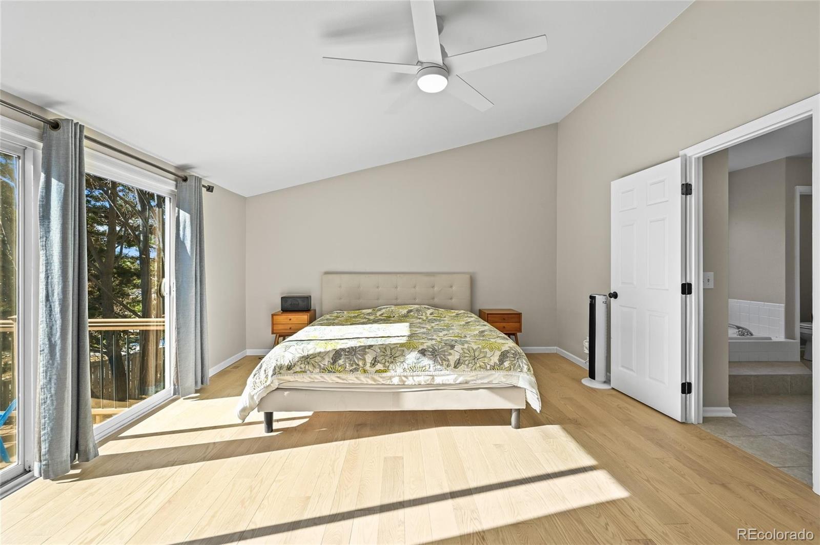 10096 Hughes Place Highlands Ranch, CO 80126 - Photo 20 of 50 a view of a bedroom with wooden floor and front door