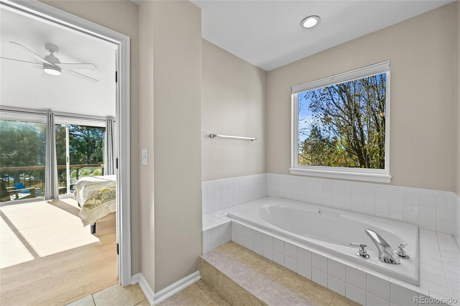 10096 Hughes Place Highlands Ranch, CO 80126 - Photo 24 of 50 a bathroom with a bathtub and a shower