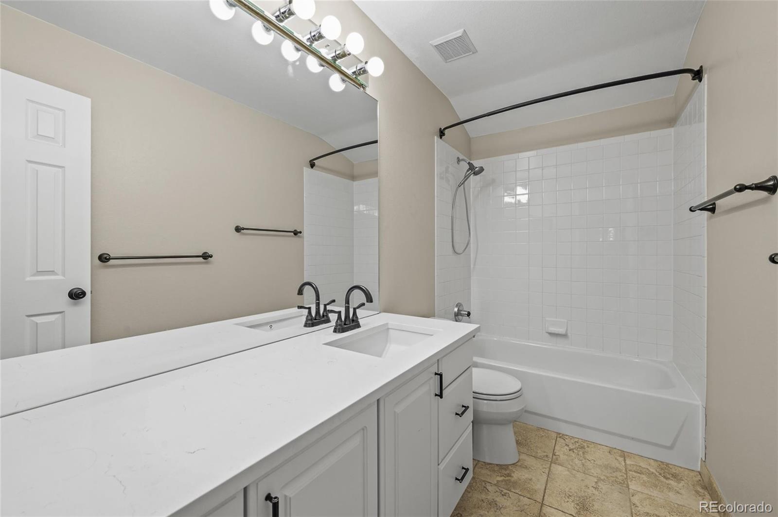 10096 Hughes Place Highlands Ranch, CO 80126 - Photo 27 of 50 a bathroom with a sink a toilet and shower