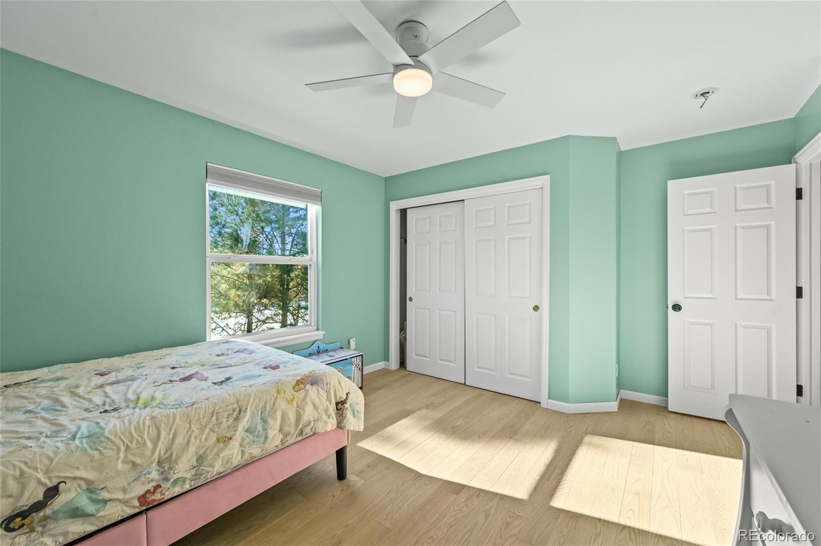 10096 Hughes Place Highlands Ranch, CO 80126 - Photo 28 of 50 a bedroom with bed and a window