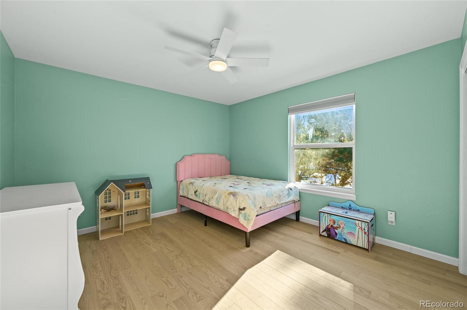 10096 Hughes Place Highlands Ranch, CO 80126 - Photo 29 of 50 a bed room with a bed and a window