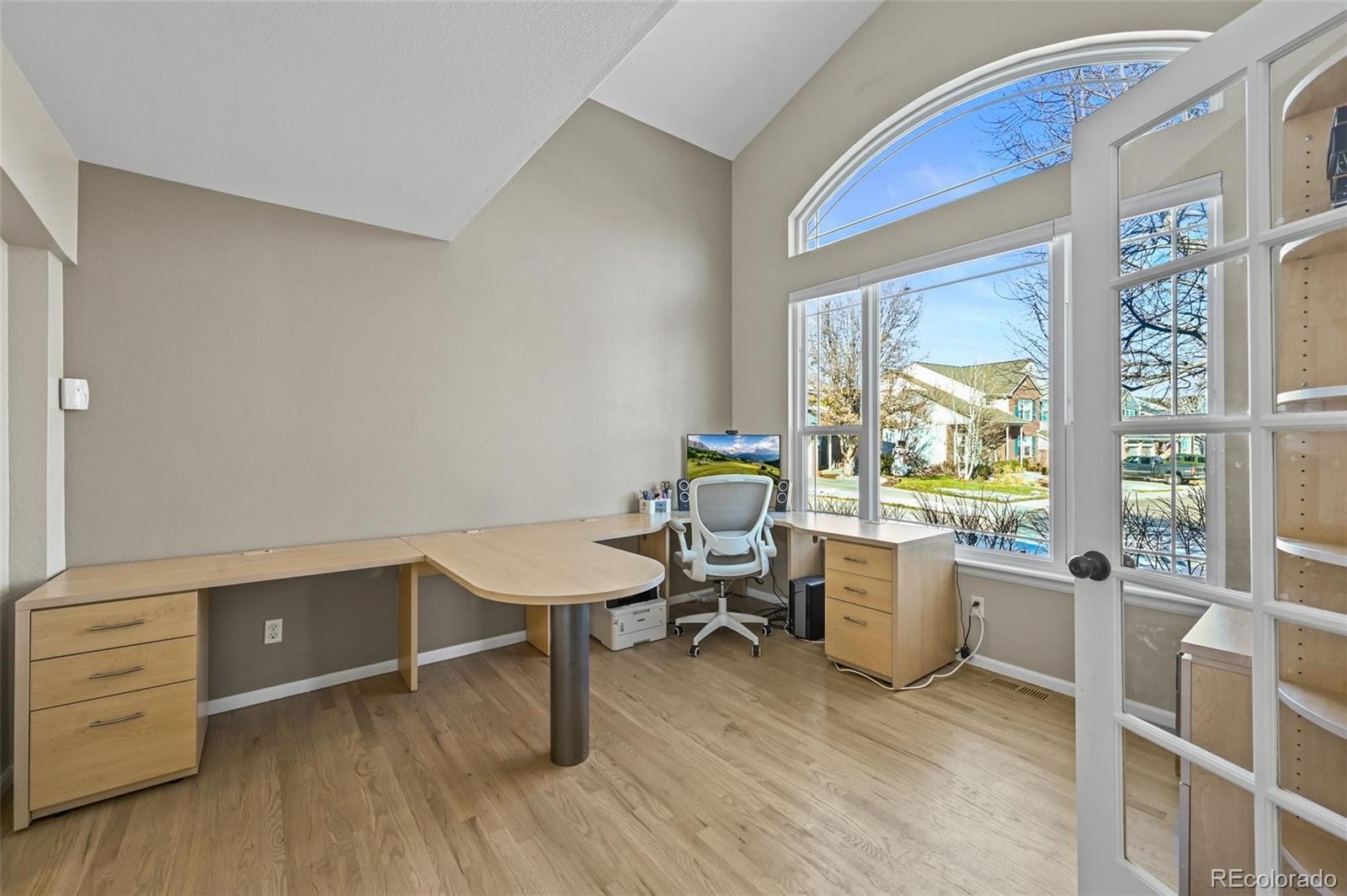 10096 Hughes Place Highlands Ranch, CO 80126 - Photo 3 of 50 a view of a workspace with furniture and a window