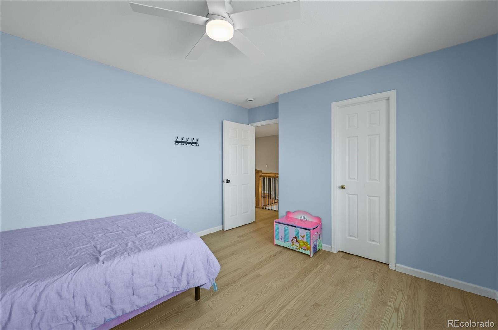 10096 Hughes Place Highlands Ranch, CO 80126 - Photo 31 of 50 a bedroom with a bed and a window