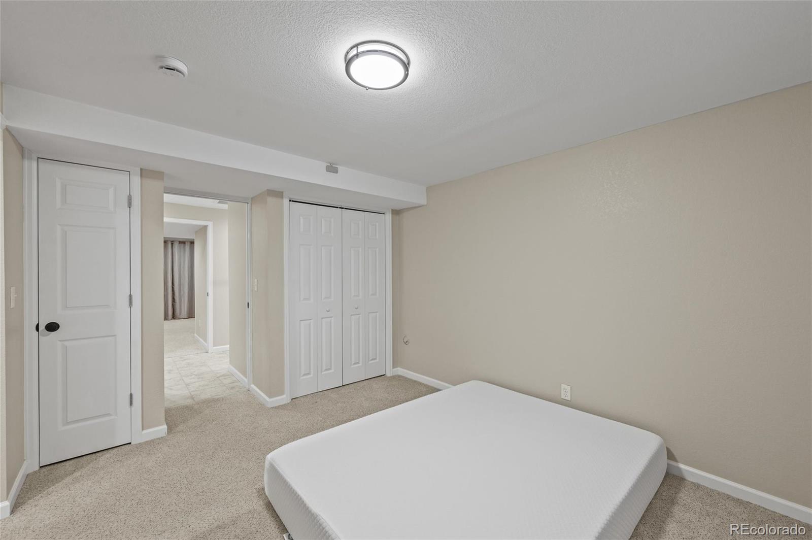 10096 Hughes Place Highlands Ranch, CO 80126 - Photo 38 of 50 a bedroom with a bed and a window