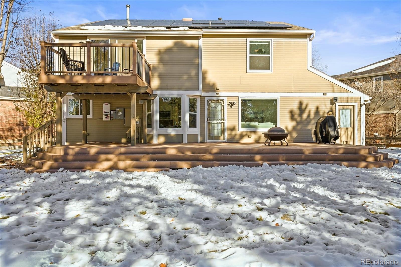 10096 Hughes Place Highlands Ranch, CO 80126 - Photo 43 of 50 a front view of a house with a yard