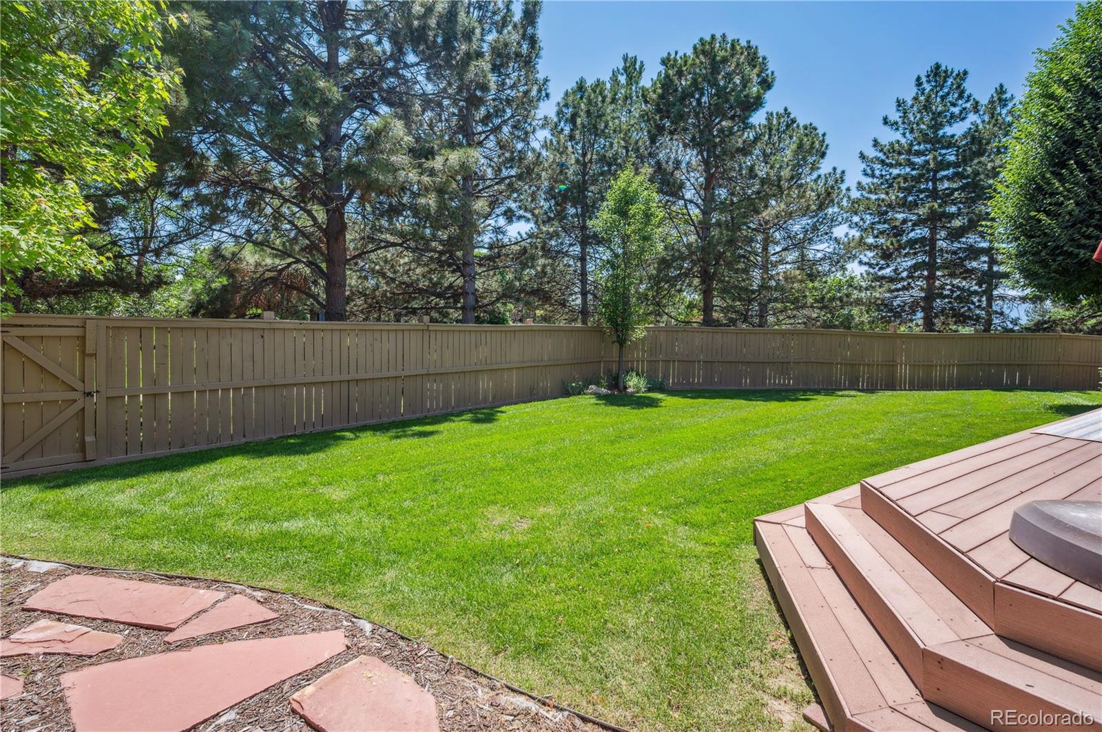 10096 Hughes Place Highlands Ranch, CO 80126 - Photo 45 of 50 a view of a backyard with a garden and entertaining space