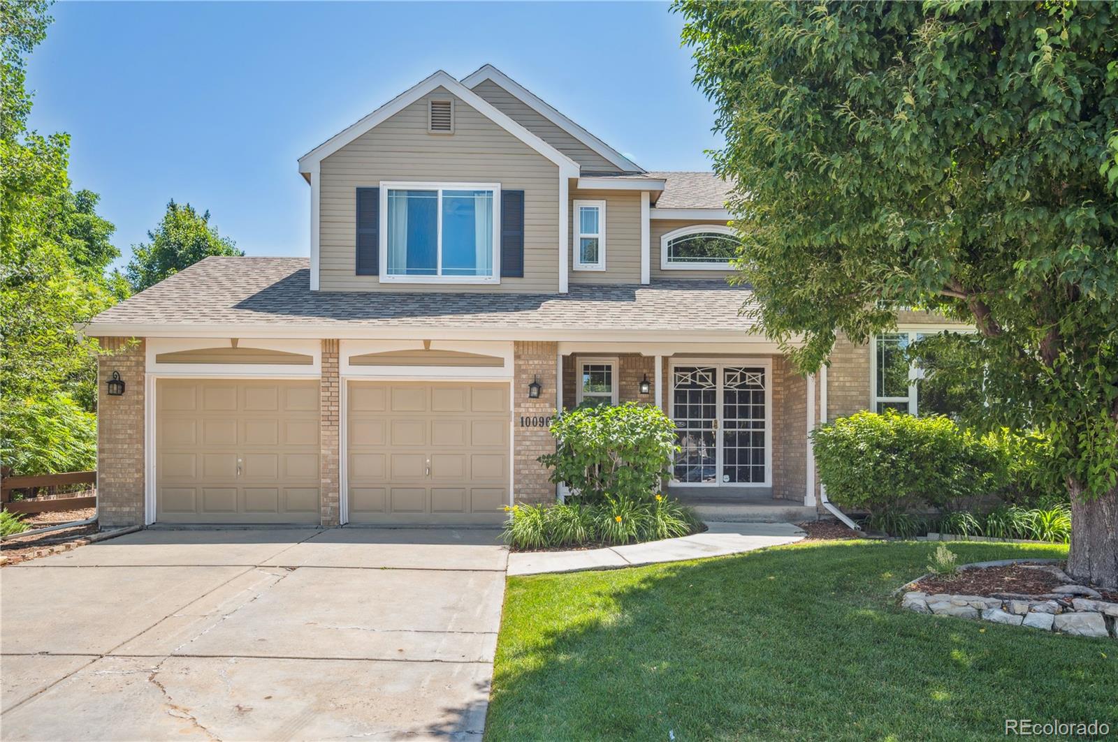 10096 Hughes Place Highlands Ranch, CO 80126 - Photo 49 of 50 a front view of a house with a yard and garage