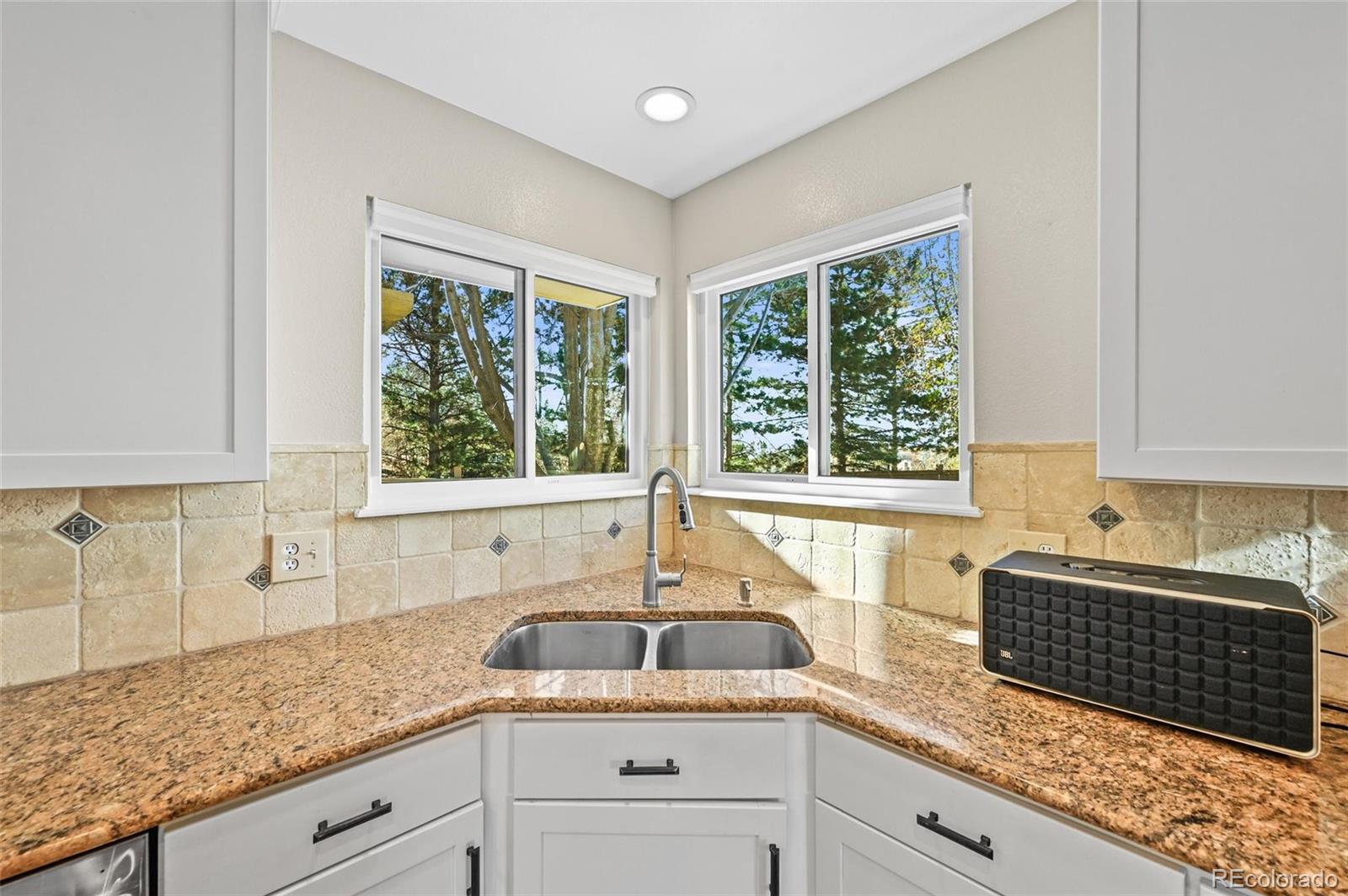 10096 Hughes Place Highlands Ranch, CO 80126 - Photo 9 of 50 a kitchen with granite countertop a sink and a window
