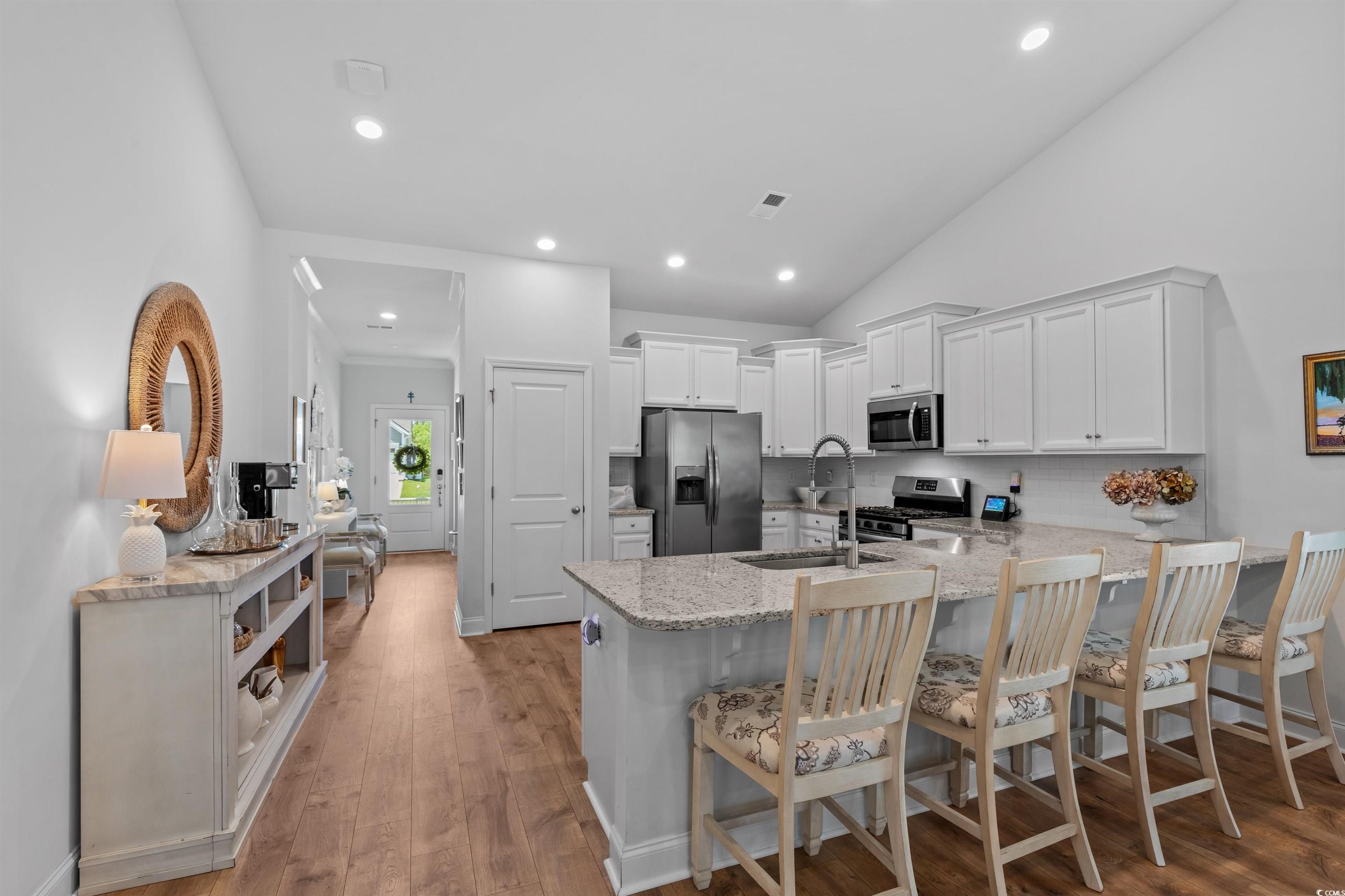2464 Rock Dove Road Myrtle Beach, SC 29577 - Photo 12 of 34 Kitchen featuring a peninsula, light stone countertops, appliances with stainless steel finishes, and a sink