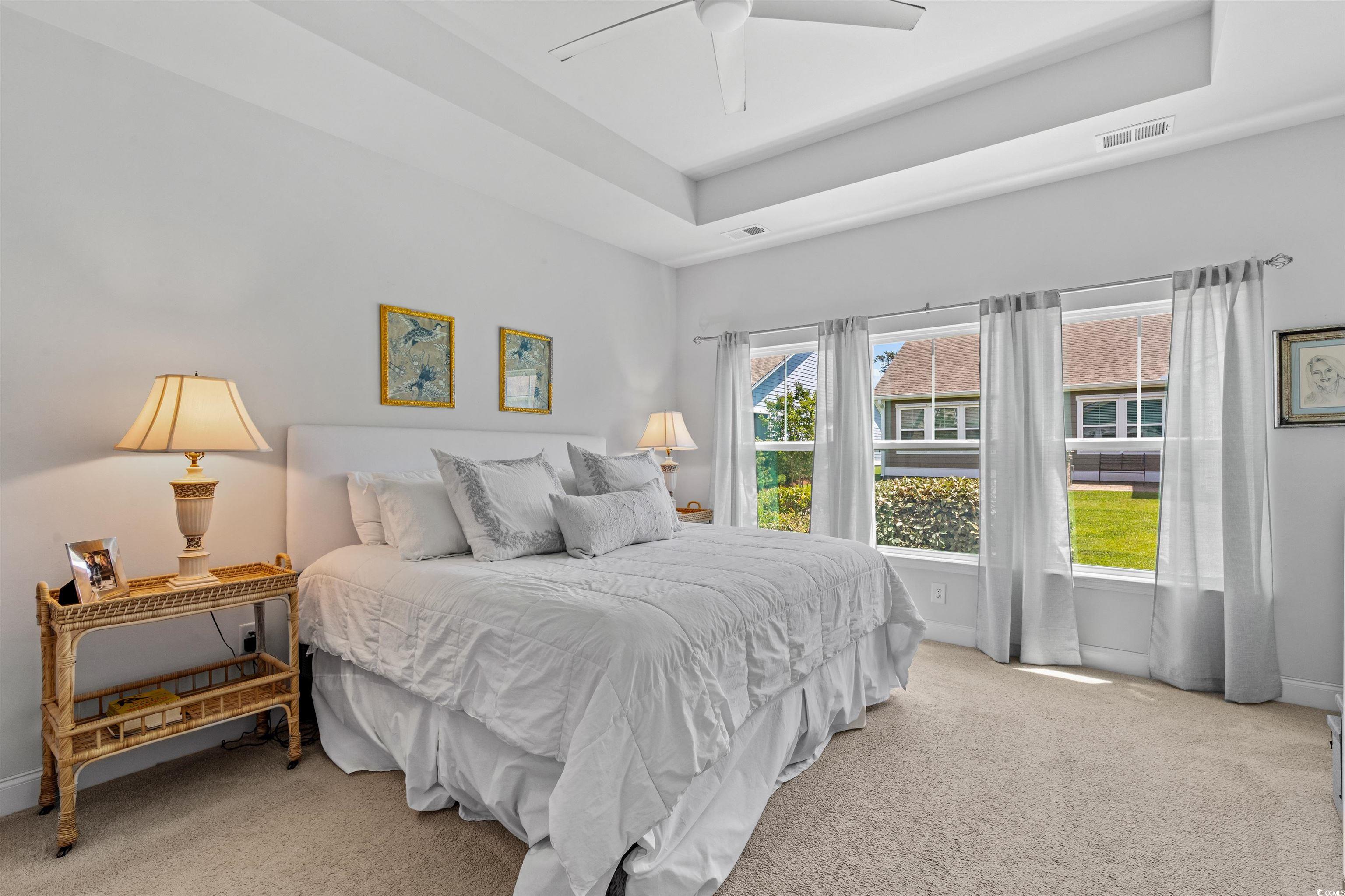 2464 Rock Dove Road Myrtle Beach, SC 29577 - Photo 16 of 34 Carpeted bedroom with baseboards, a ceiling fan, a tray ceiling, and visible vents