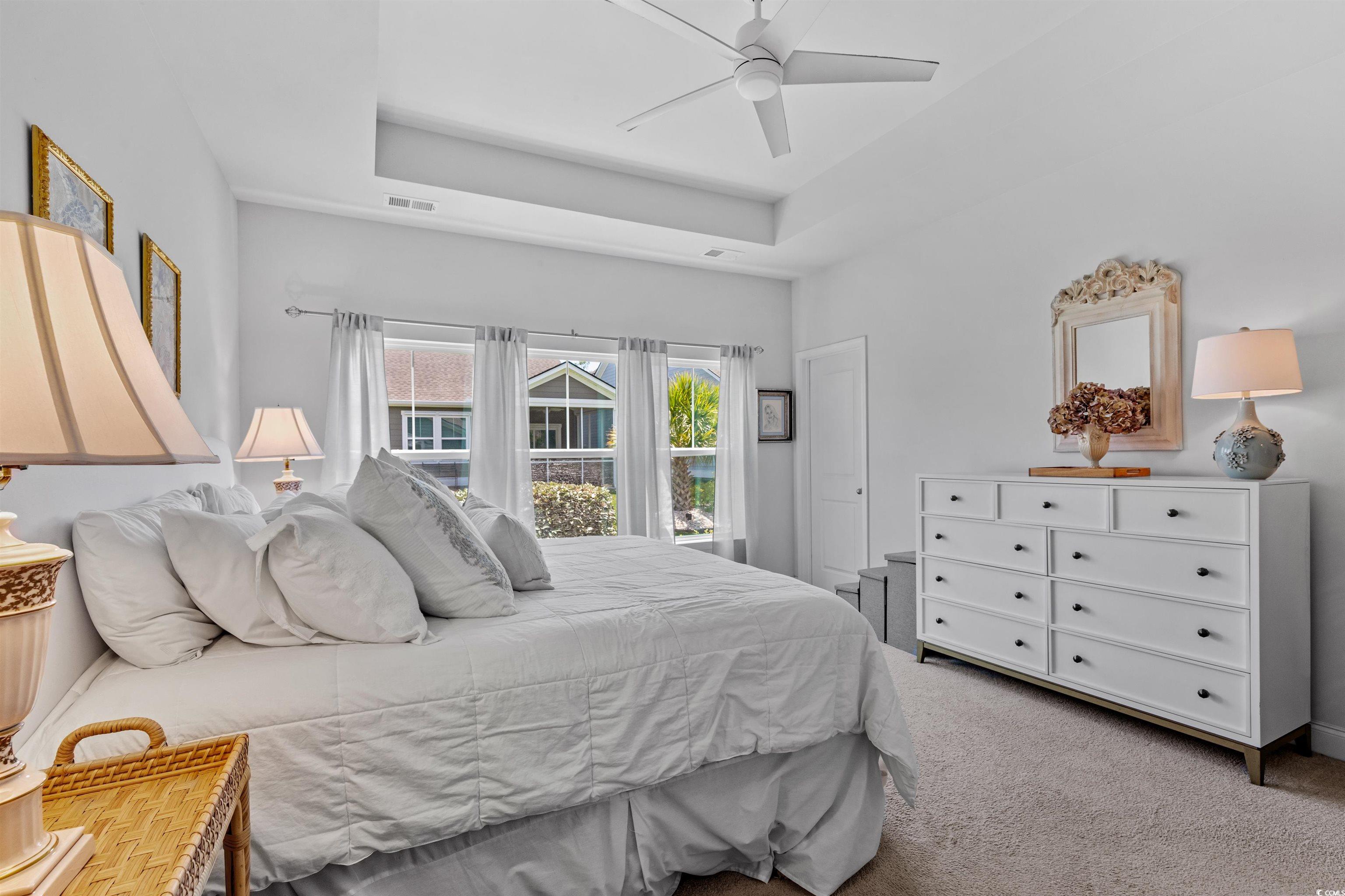 2464 Rock Dove Road Myrtle Beach, SC 29577 - Photo 17 of 34 Bedroom featuring a raised ceiling, ceiling fan, carpet flooring, and visible vents