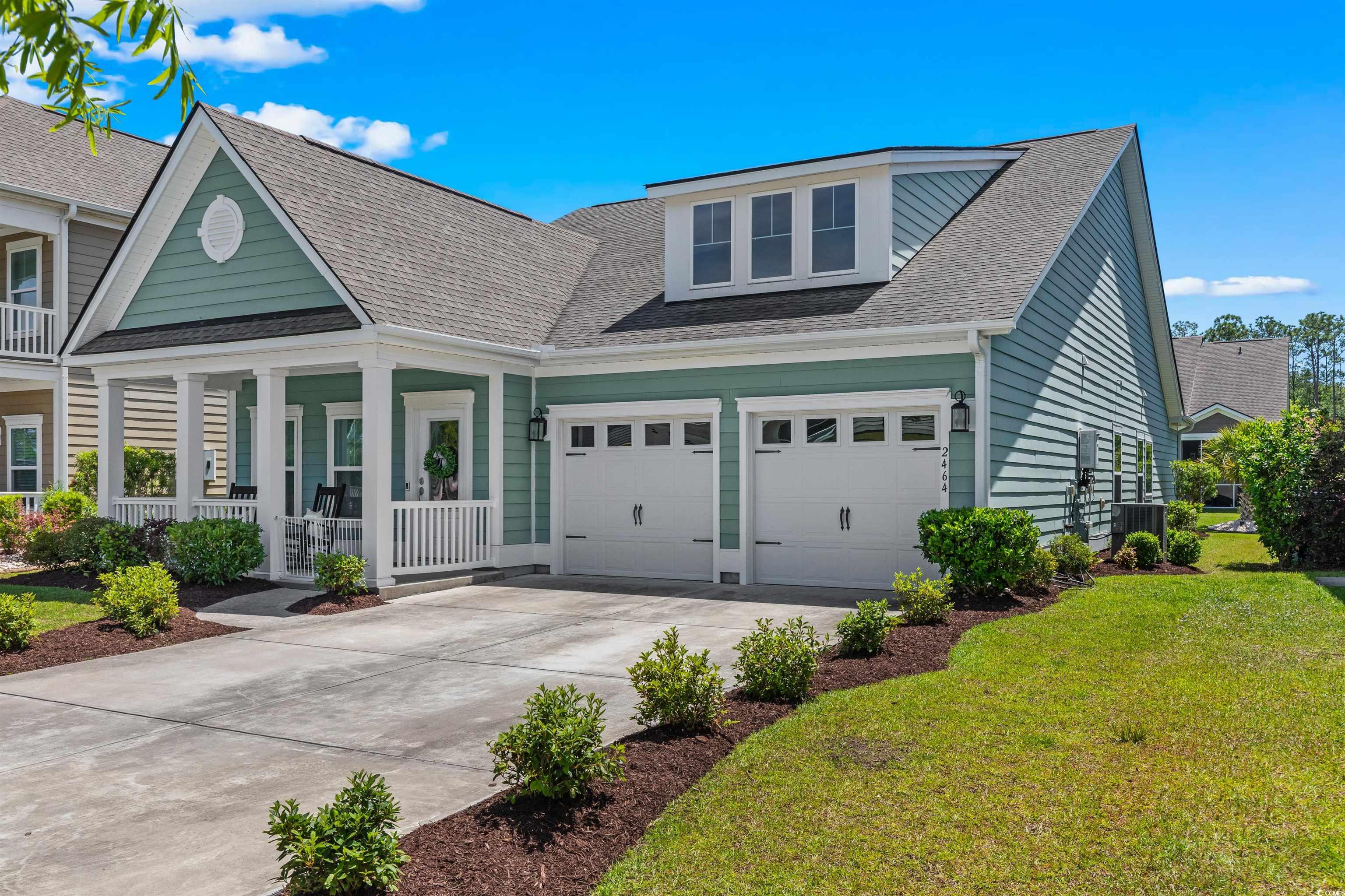 2464 Rock Dove Road Myrtle Beach, SC 29577 - Photo 2 of 34 View of front of house with covered porch, central AC unit, a front lawn, concrete driveway, and a shingled roof