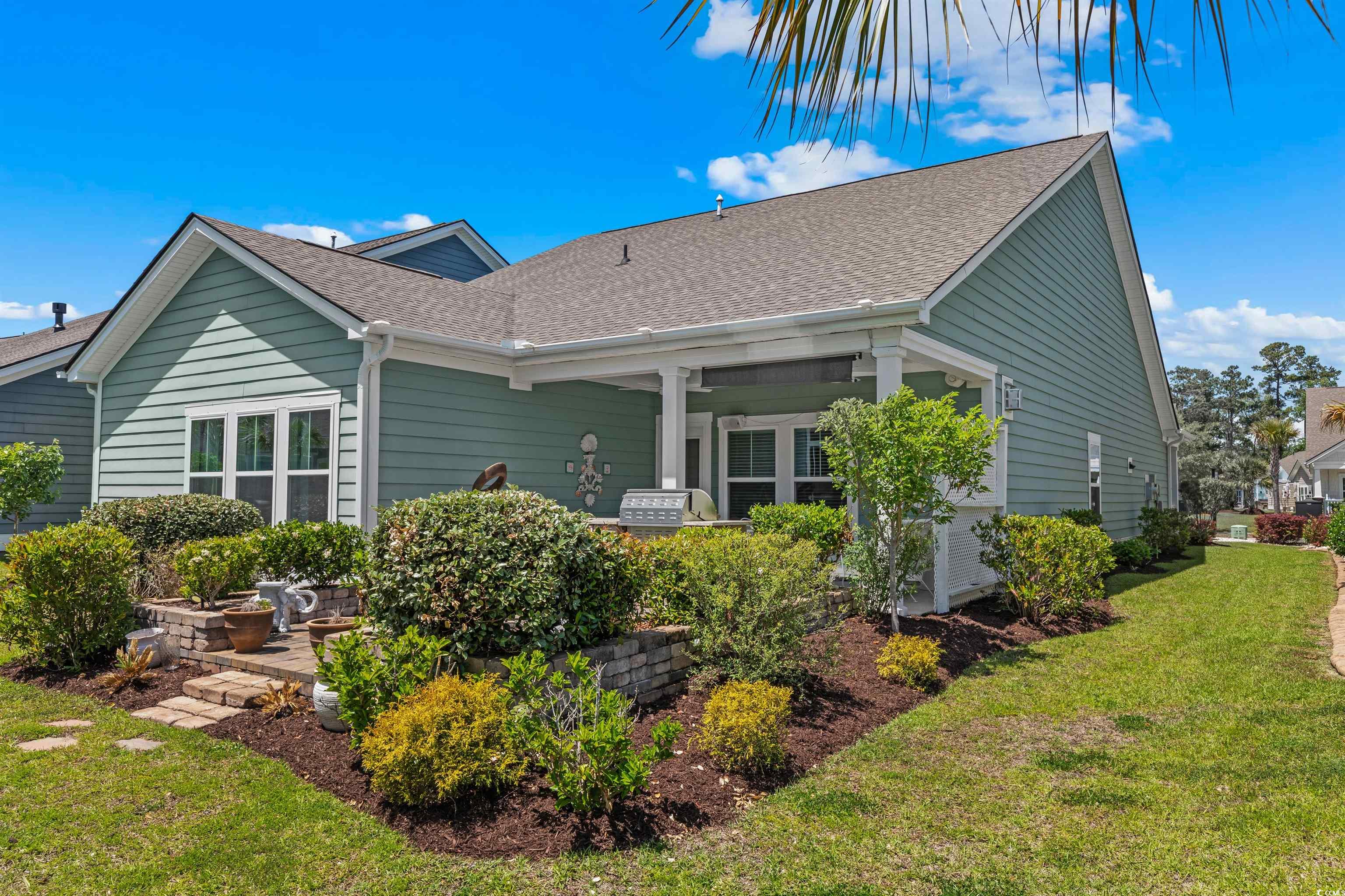 2464 Rock Dove Road Myrtle Beach, SC 29577 - Photo 25 of 34 Back of house featuring roof with shingles and a yard