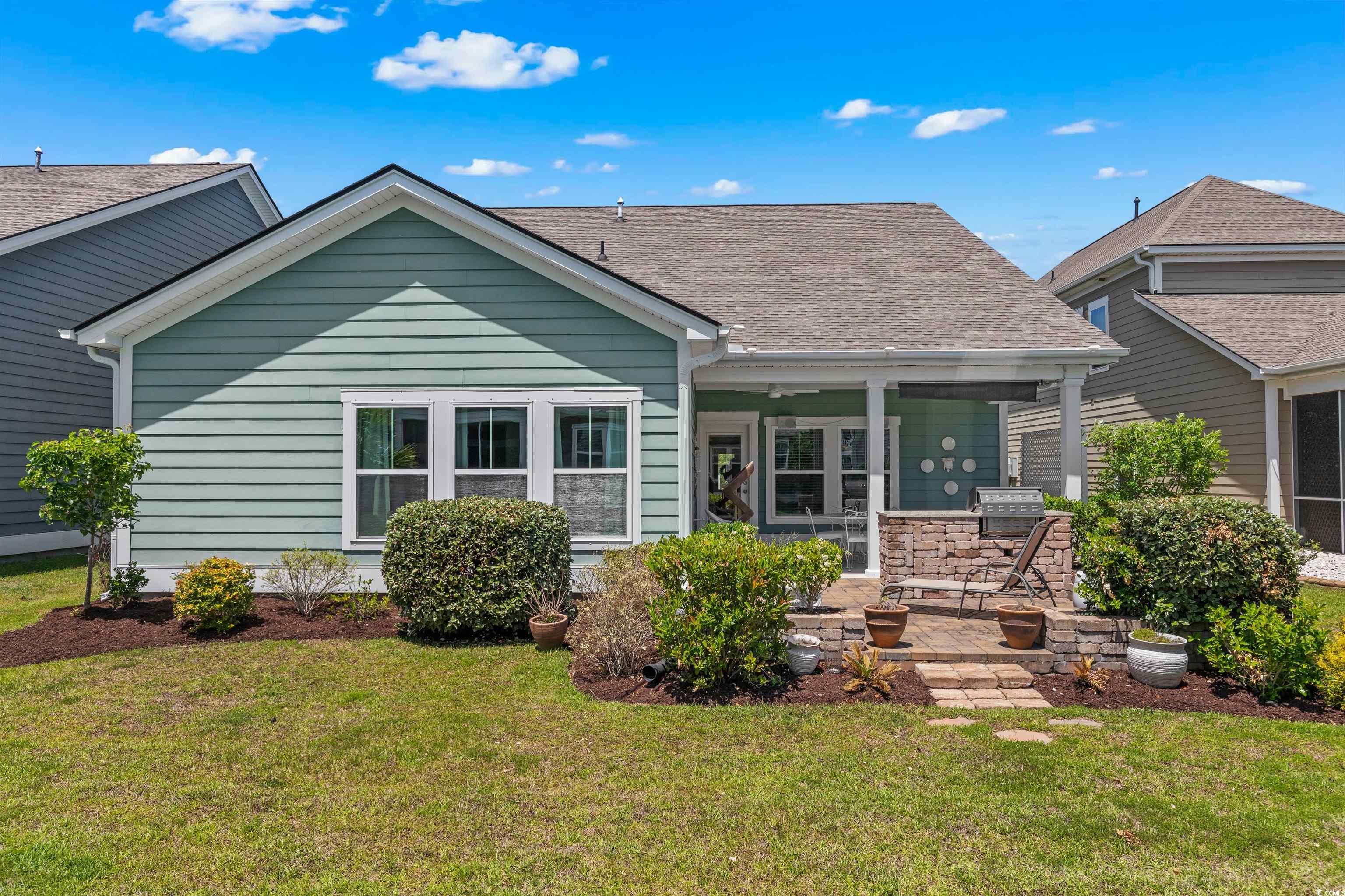 2464 Rock Dove Road Myrtle Beach, SC 29577 - Photo 26 of 34 Rear view of property with a lawn, a shingled roof, and a patio area