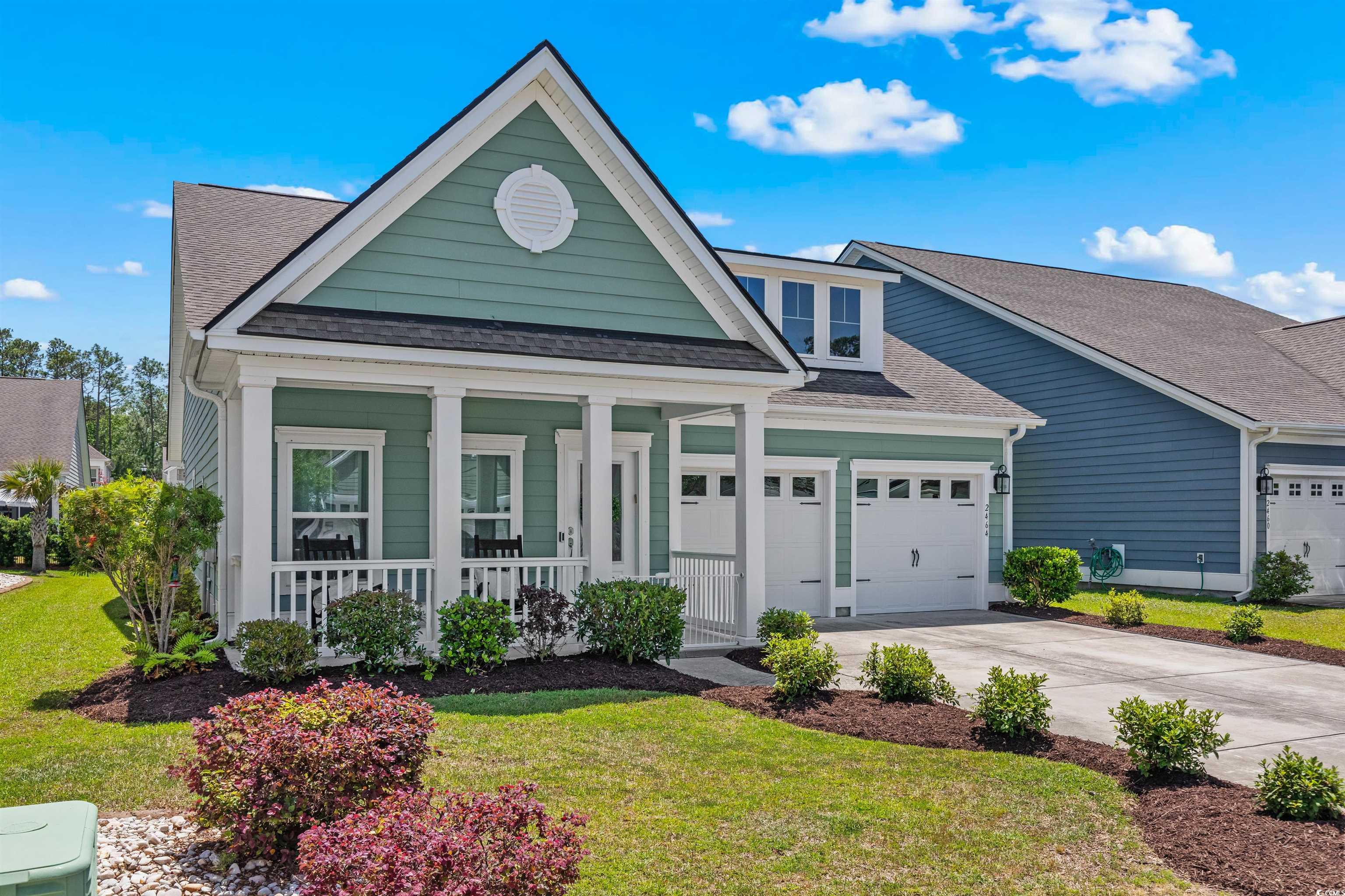 2464 Rock Dove Road Myrtle Beach, SC 29577 - Photo 3 of 34 View of front facade with a front lawn, roof with shingles, an attached garage, driveway, and a porch