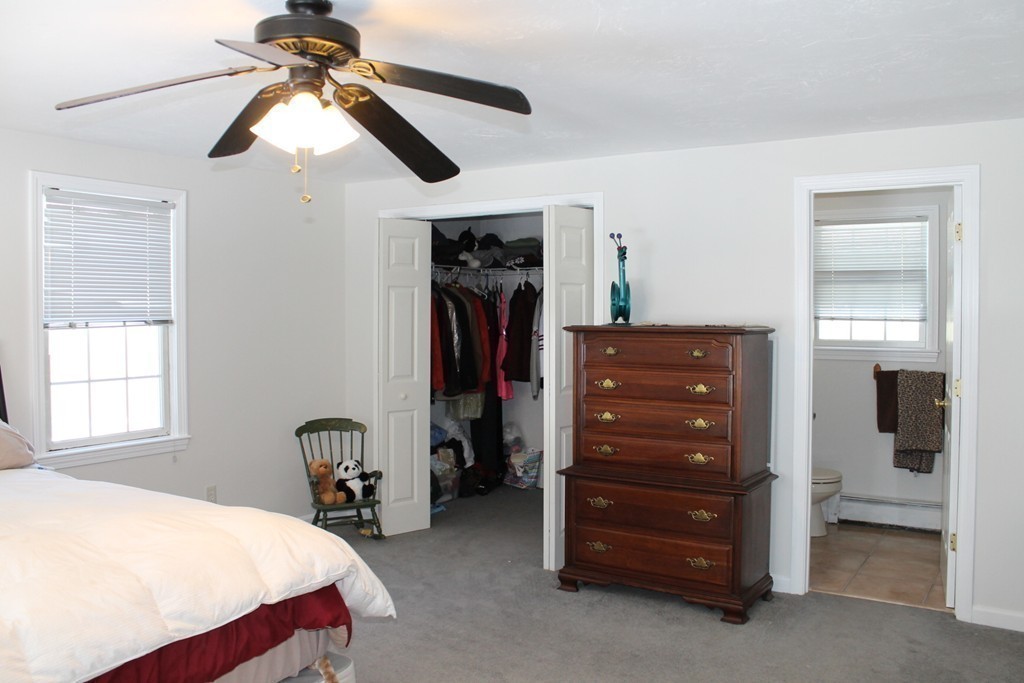 124 Mashapaug Road Sturbridge, MA 01566 - Photo 14 of 30 a bedroom with a bed and a dresser