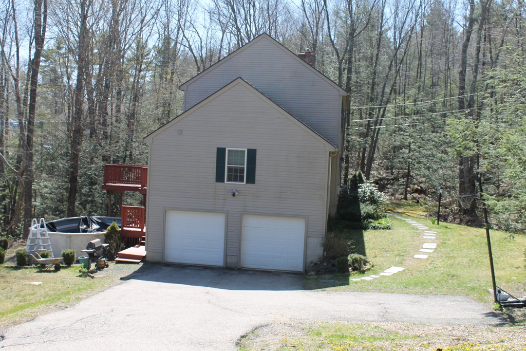 124 Mashapaug Road Sturbridge, MA 01566 - Photo 25 of 30 a view of a house with backyard and sitting area