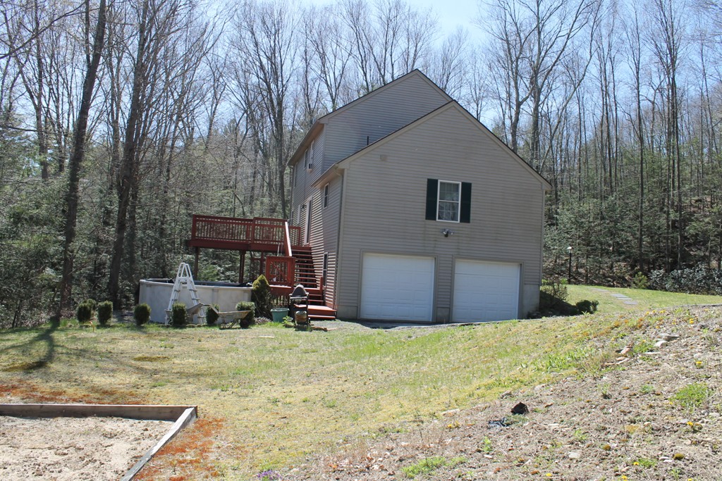 124 Mashapaug Road Sturbridge, MA 01566 - Photo 3 of 30 a view of a house with backyard and trees
