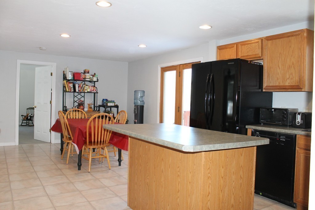 124 Mashapaug Road Sturbridge, MA 01566 - Photo 4 of 30 a kitchen with stainless steel appliances granite countertop a refrigerator a sink and a stove