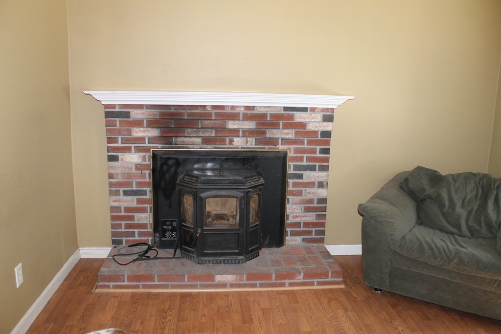 124 Mashapaug Road Sturbridge, MA 01566 - Photo 8 of 30 a living room with furniture and a fireplace