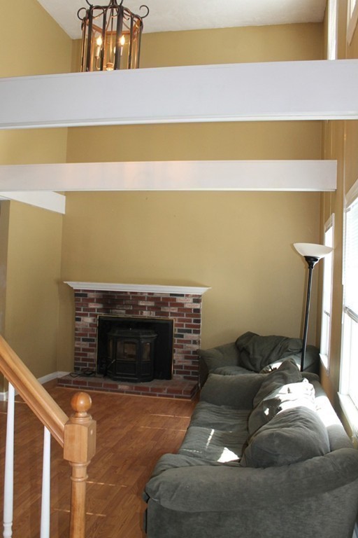 124 Mashapaug Road Sturbridge, MA 01566 - Photo 9 of 30 a living room with furniture and a fireplace