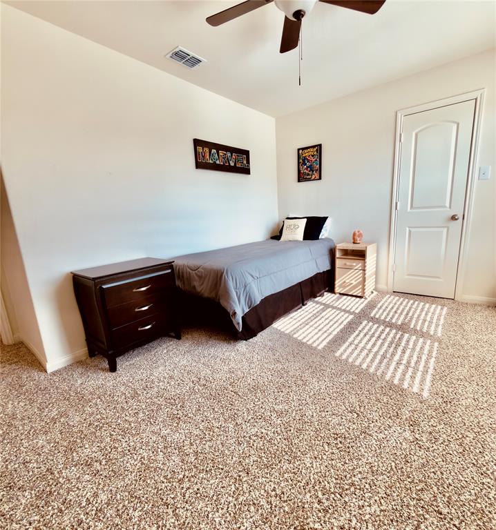 196 Cattlemans Crk Road West Newark, TX 76071 - Photo 13 of 24 Plush carpeting throughout, neutral wall paint, ceiling fan with light fixture, white interior door, and a built-in ceiling vent