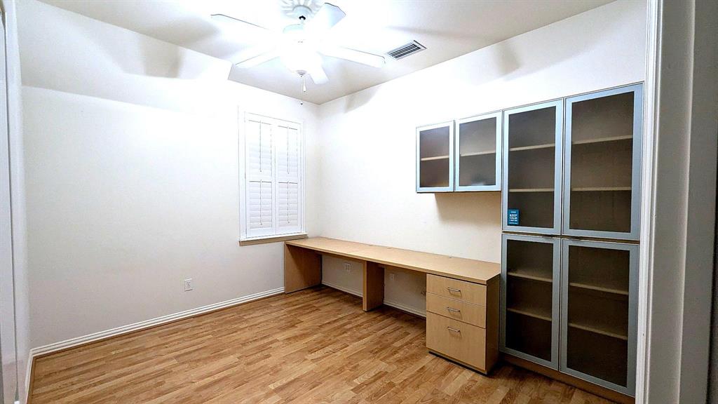 4209 Sexton Lane Dallas, TX 75229 - Photo 22 of 27 a view of an empty room with a window and wooden floor