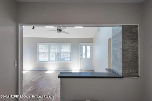 a kitchen with stainless steel appliances granite countertop a sink a stove a microwave and wooden cabinets