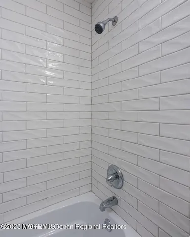 a balcony with wooden floor outdoor seating and yard in the back