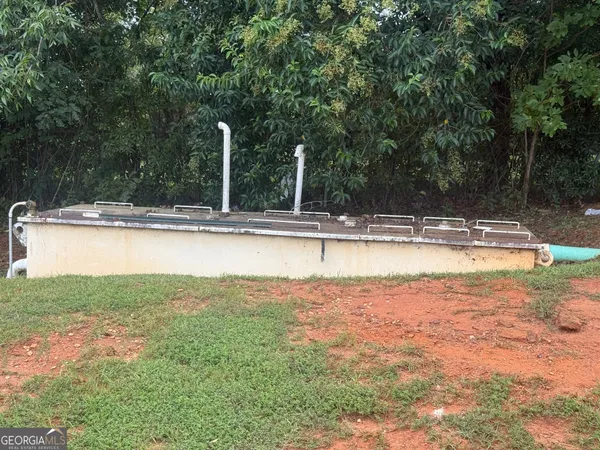 a view of a swimming pool and a yard