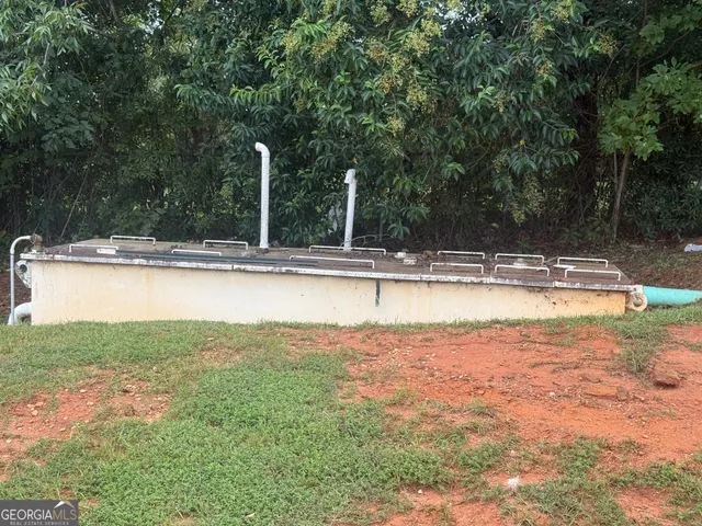 a view of a swimming pool and a yard