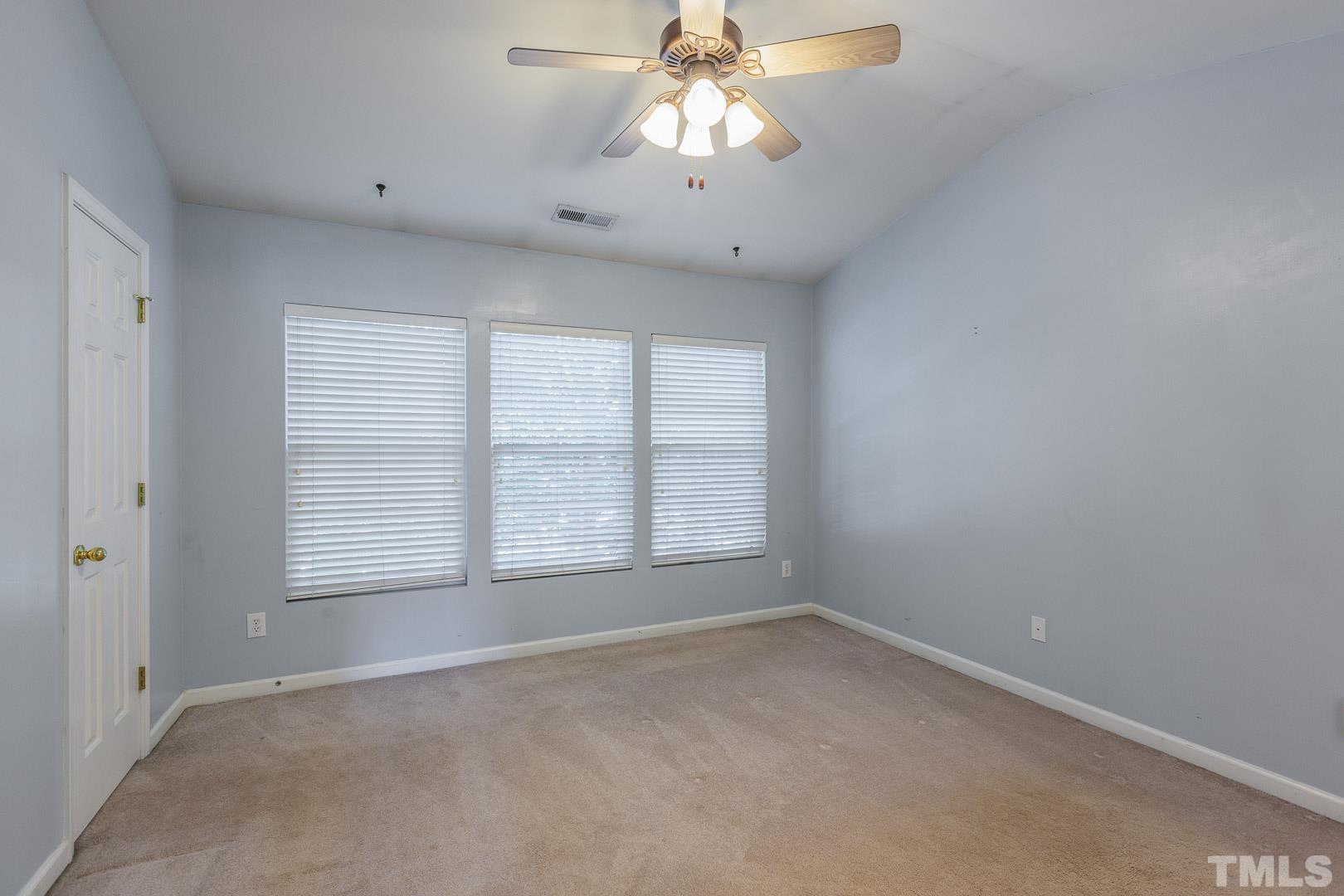 1731 Sorrell Brook Way Raleigh, NC 27609 - Photo 17 of 26 an empty room with a window and a fan
