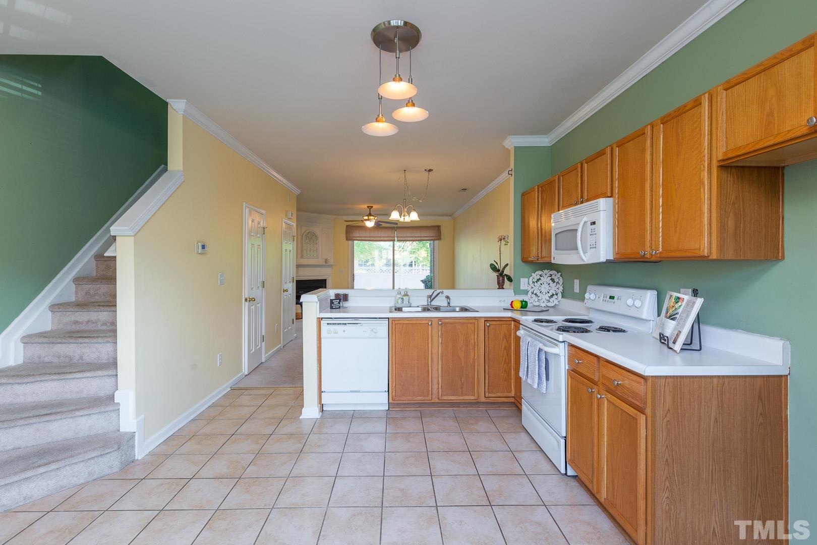 1731 Sorrell Brook Way Raleigh, NC 27609 - Photo 3 of 26 a kitchen with a sink cabinets and window