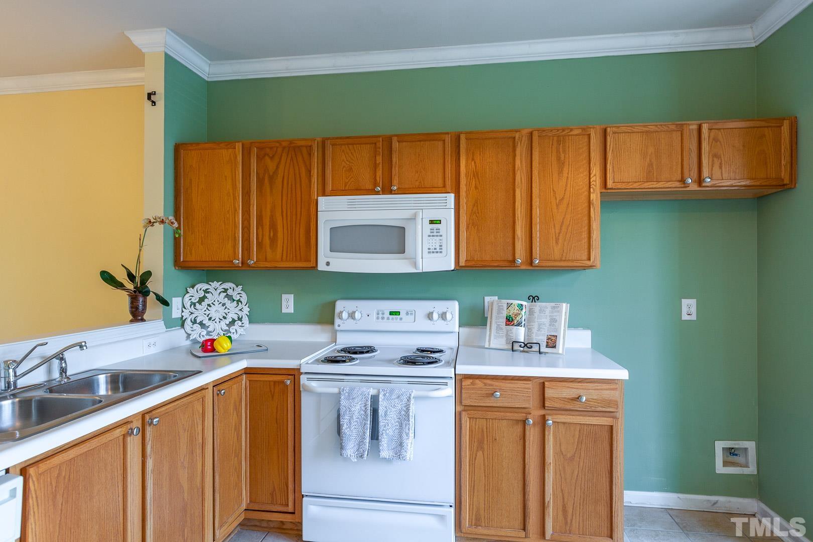 1731 Sorrell Brook Way Raleigh, NC 27609 - Photo 6 of 26 a kitchen with stainless steel appliances a sink dishwasher stove and cabinets
