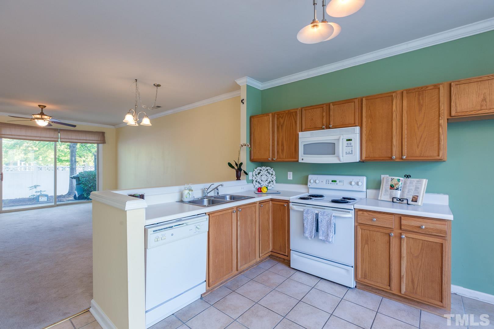 1731 Sorrell Brook Way Raleigh, NC 27609 - Photo 8 of 26 a kitchen that has a sink and cabinets in it