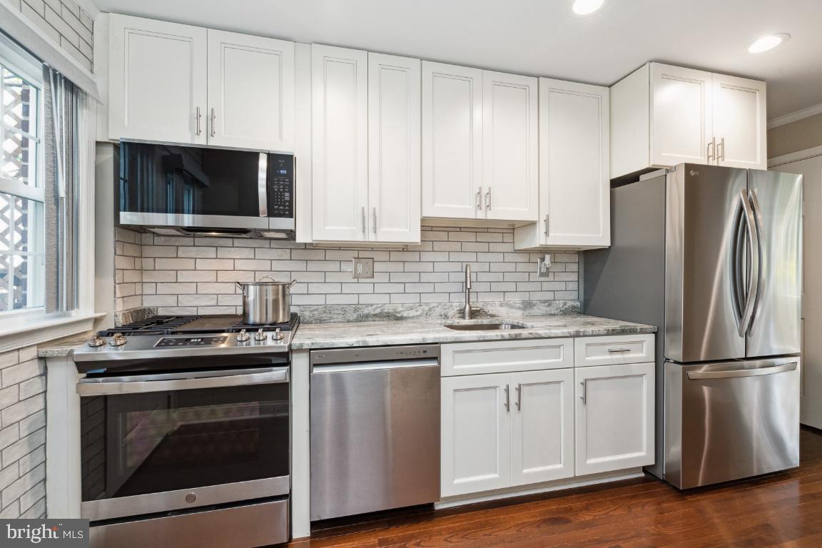 124 Brandon Road Baltimore, MD 21212 - Photo 9 of 25 Gas stove, dishwasher and double door fridge