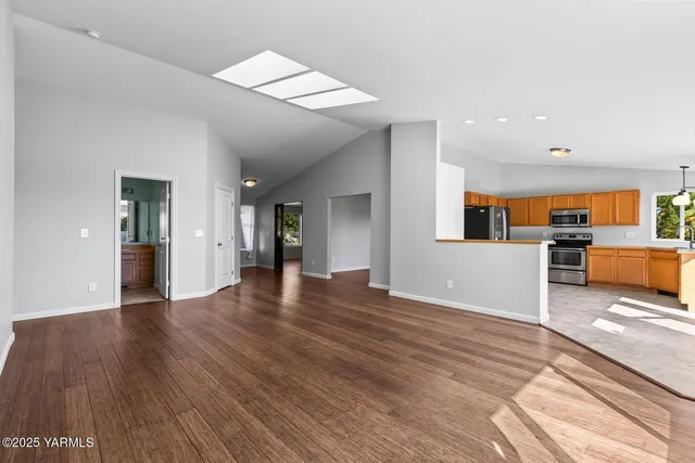 a view of a kitchen with wooden floor and a sink
