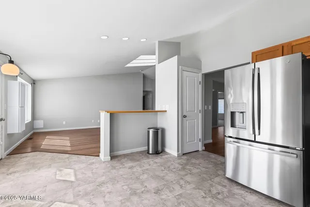 a kitchen with stainless steel appliances a refrigerator and microwave