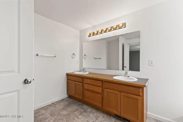 a hall with a sink and a mirror
