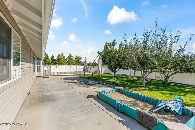 a view of a backyard with swimming pool