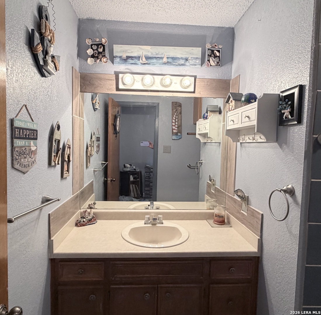 116 Debra Lane Hunt, TX 78024 - Photo 11 of 34 a bathroom with a sink and a mirror